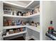 Walk-in pantry featuring custom shelving and ample storage space for food and appliances at 1165 Victoria Ne St, Brookhaven, GA 30319