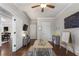 Spacious playroom featuring hardwood floors, a ceiling fan, and direct access to other living areas at 1165 Victoria Ne St, Brookhaven, GA 30319