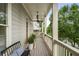 Cozy covered porch with a bench, potted plants, and a ceiling fan for relaxed outdoor living at 1165 Victoria Ne St, Brookhaven, GA 30319