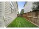 Practical side yard with well-maintained lawn and a wooden fence, offering privacy and utility at 1165 Victoria Ne St, Brookhaven, GA 30319