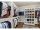 Well-organized walk-in closet with custom shelving and hardwood floors at 1165 Victoria Ne St, Brookhaven, GA 30319