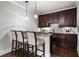 The wet bar features dark cabinets, pendant lighting, and bar stool seating at 1165 Victoria Ne St, Brookhaven, GA 30319