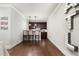 The wet bar features dark cabinets, pendant lighting, and bar stool seating at 1165 Victoria Ne St, Brookhaven, GA 30319