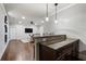 The wet bar features dark cabinets, pendant lighting, and bar stool seating near living room at 1165 Victoria Ne St, Brookhaven, GA 30319