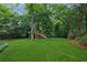 This large backyard features a playset and mature trees at 1349 Middlesex Ne Ave, Atlanta, GA 30306