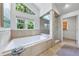 Luxury bathroom showcasing a soaking tub, large windows, and a glass-enclosed shower at 1349 Middlesex Ne Ave, Atlanta, GA 30306