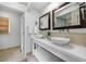 Bright bathroom featuring dual sinks, stone countertops, framed mirrors, and modern fixtures at 1349 Middlesex Ne Ave, Atlanta, GA 30306