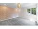 Well-lit bedroom with a patterned accent wall and elegant chandelier at 1349 Middlesex Ne Ave, Atlanta, GA 30306