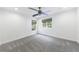 Bedroom featuring plush gray carpet, a modern ceiling fan, and two windows at 1349 Middlesex Ne Ave, Atlanta, GA 30306