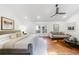 Sunlit bedroom with vaulted ceiling, hardwood floors, seating area, and minimalist decor at 1349 Middlesex Ne Ave, Atlanta, GA 30306
