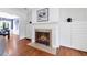 Close-up of a cozy fireplace, featuring white cabinetry and hardwood floors at 1349 Middlesex Ne Ave, Atlanta, GA 30306