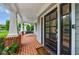Close-up of a charming front porch featuring brick flooring, a cozy porch swing, and an elegant front door at 1349 Middlesex Ne Ave, Atlanta, GA 30306