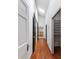Hallway with skylight, hardwood floors, white walls, and doors leading to various rooms at 1349 Middlesex Ne Ave, Atlanta, GA 30306