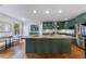 Well-lit kitchen with large island, stainless steel appliances, and green cabinetry at 1349 Middlesex Ne Ave, Atlanta, GA 30306