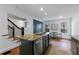 Kitchen island with granite countertop, stainless steel appliances, dark cabinets, and hardwood floors at 1349 Middlesex Ne Ave, Atlanta, GA 30306