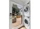 Laundry area featuring stacked washer and dryer with view of the outdoor deck at 1349 Middlesex Ne Ave, Atlanta, GA 30306