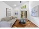 Bright living room featuring a vaulted ceiling, modern art and light gray sofa with a brown cowhide rug at 1349 Middlesex Ne Ave, Atlanta, GA 30306