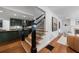 Elegant staircase with dark wood railings and hardwood floors, connecting to the kitchen and living room at 1349 Middlesex Ne Ave, Atlanta, GA 30306