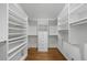 Custom designed walk-in closet featuring ample storage space including custom shelves, drawers, and wood flooring at 1349 Middlesex Ne Ave, Atlanta, GA 30306