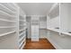 This walk-in closet features custom shelves, drawers, and ample storage space with wood flooring throughout at 1349 Middlesex Ne Ave, Atlanta, GA 30306
