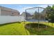 Fenced backyard featuring a trampoline and mature trees at 2267 Clapton Ct, Jonesboro, GA 30236