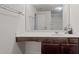 Bright bathroom featuring a large mirror above a white sink with dark cabinets at 2267 Clapton Ct, Jonesboro, GA 30236