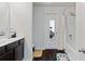 A well-lit bathroom featuring a shower-tub combo with a shower curtain and dark wood cabinets at 2267 Clapton Ct, Jonesboro, GA 30236