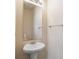 Clean powder room featuring a pedestal sink, mirror, and neutral walls at 2267 Clapton Ct, Jonesboro, GA 30236