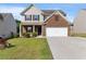 Charming two-story home with brick and vinyl siding, featuring a two-car garage and well-manicured lawn at 2267 Clapton Ct, Jonesboro, GA 30236