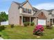 Attractive home with colorful flowers in the yard and well-maintained landscaping at 2267 Clapton Ct, Jonesboro, GA 30236
