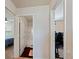 Hallway providing access to a bathroom featuring a tub and a bedroom with a blue bedspread at 2267 Clapton Ct, Jonesboro, GA 30236