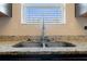 Close up of kitchen sink and granite countertop underneath a window at 2267 Clapton Ct, Jonesboro, GA 30236