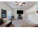 Bright living room featuring a ceiling fan and a wall-mounted TV at 2267 Clapton Ct, Jonesboro, GA 30236
