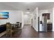 Open floorplan with dark wood floors, dining area, and stainless steel refrigerator at 2267 Clapton Ct, Jonesboro, GA 30236