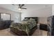 Spacious main bedroom featuring a large bed, dresser, and ceiling fan at 2267 Clapton Ct, Jonesboro, GA 30236