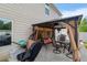 Covered patio with outdoor furniture, swing, and grill for entertaining at 2267 Clapton Ct, Jonesboro, GA 30236