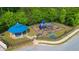 Aerial view of a colorful community playground featuring a gazebo, slides, and climbing structures for enjoyment at 2267 Clapton Ct, Jonesboro, GA 30236