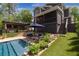 This backyard features a pool with a covered patio, outdoor kitchen, and beautifully landscaped areas at 2406 Glenwood Ne Dr, Atlanta, GA 30305