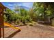 A backyard play area with a slide and trampoline amidst lush greenery offers fun for all at 2406 Glenwood Ne Dr, Atlanta, GA 30305
