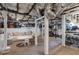 Spacious basement area with gym equipment, a sofa, a table and chairs, and exposed ducts at 2406 Glenwood Ne Dr, Atlanta, GA 30305