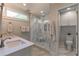 Modern bathroom featuring marble shower with glass door, double sinks, and a separate toilet area at 2406 Glenwood Ne Dr, Atlanta, GA 30305