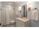 Classic bathroom with subway tile shower, vanity, decorative fixtures, and black and white tile floor at 2406 Glenwood Ne Dr, Atlanta, GA 30305