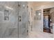 Elegant bathroom with glass-enclosed marble shower, built-in shelves, and adjacent closet at 2406 Glenwood Ne Dr, Atlanta, GA 30305
