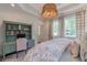 Bedroom with a built in bookshelf, desk and large windows offering ample natural light at 2406 Glenwood Ne Dr, Atlanta, GA 30305
