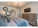 Elegant bedroom featuring a decorative chandelier, stylish round mirrors, and a spacious wooden dresser at 2406 Glenwood Ne Dr, Atlanta, GA 30305