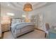 Charming bedroom featuring a tray ceiling, neutral color palette, and decorative wicker light fixture at 2406 Glenwood Ne Dr, Atlanta, GA 30305