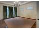 Bright dining room featuring green curtains, two windows, a tan carpet, and a decorative chandelier at 2406 Glenwood Ne Dr, Atlanta, GA 30305