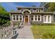 Inviting home featuring a beautifully landscaped front yard with a charming front porch at 2406 Glenwood Ne Dr, Atlanta, GA 30305