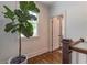 Upstairs hallway with potted tree and a doorway leading to another room at 2406 Glenwood Ne Dr, Atlanta, GA 30305