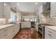 Well-lit kitchen with island, white cabinets and stainless steel appliances at 2406 Glenwood Ne Dr, Atlanta, GA 30305